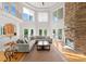 Grand living room with soaring ceilings, stone fireplace, and abundant natural light from large windows at 4145 Cindy Ln, Denver, NC 28037