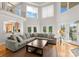 Bright, airy living room featuring soaring ceilings, large windows, and an open floor plan, perfect for entertaining at 4145 Cindy Ln, Denver, NC 28037