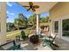 Scenic covered patio with fan, fire pit, outdoor seating, and lake views at 4145 Cindy Ln, Denver, NC 28037