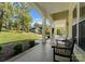 Inviting covered porch with decorative columns, lush landscaping, and comfortable seating, perfect for relaxing at 4145 Cindy Ln, Denver, NC 28037