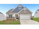 Two-story home with gray and blue siding, stone accents, and a two-car garage at 4469 Doyle Ridge Rd, Maiden, NC 28650