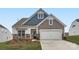 Two-story home with gray and blue siding, stone accents, and a two-car garage at 4469 Doyle Ridge Rd, Maiden, NC 28650