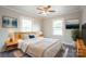 Bedroom with light wood bed frame, neutral decor, and ceiling fan at 83 Woodsdale Se Pl, Concord, NC 28025