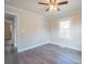 Bright bedroom with hardwood floors and ceiling fan at 83 Woodsdale Se Pl, Concord, NC 28025