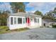 Front view of charming house with red door at 83 Woodsdale Se Pl, Concord, NC 28025