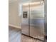 Stainless steel refrigerator in a kitchen with light gray floors at 83 Woodsdale Se Pl, Concord, NC 28025