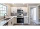 Modern kitchen with white cabinets, stainless steel appliances, and quartz countertops at 83 Woodsdale Se Pl, Concord, NC 28025