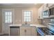 Modern kitchen with white cabinets, stainless steel appliances, and quartz countertops at 83 Woodsdale Se Pl, Concord, NC 28025