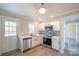 Modern kitchen with white cabinets, stainless steel appliances, and quartz countertops at 83 Woodsdale Se Pl, Concord, NC 28025