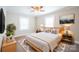 Spacious bedroom with light wood bed frame, neutral decor, and ceiling fan at 83 Woodsdale Se Pl, Concord, NC 28025