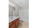 Bathroom with tub and wood vanity at 9826 Edinburgh Ln # 282, Charlotte, NC 28269