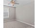 Well-lit bedroom with window, ceiling fan and neutral walls at 9826 Edinburgh Ln # 282, Charlotte, NC 28269