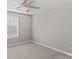 Bright bedroom with window and ceiling fan at 9826 Edinburgh Ln # 282, Charlotte, NC 28269