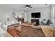 Open living room with hardwood floors and a view to the dining area at 15634 Normans Landing Dr, Charlotte, NC 28273