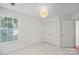 Simple bedroom with window, closet, and neutral walls at 10423 Brawley Ln, Charlotte, NC 28215