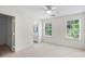 Well-lit bedroom featuring a ceiling fan and access to an ensuite bathroom at 10423 Brawley Ln, Charlotte, NC 28215