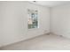 Small bedroom with window and neutral walls at 10423 Brawley Ln, Charlotte, NC 28215