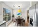 Cozy breakfast nook featuring a modern light fixture and view of outdoors at 10423 Brawley Ln, Charlotte, NC 28215