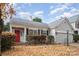 Charming ranch home with red door and autumn leaves at 10423 Brawley Ln, Charlotte, NC 28215