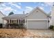 Gray exterior ranch home with two-car garage at 10423 Brawley Ln, Charlotte, NC 28215