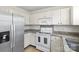 Kitchen features stainless steel appliances, granite countertops, and white cabinetry at 10423 Brawley Ln, Charlotte, NC 28215