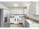 Modern kitchen featuring white cabinetry, stainless steel appliances, and granite countertops at 10423 Brawley Ln, Charlotte, NC 28215