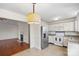 Kitchen featuring stainless steel appliances, white cabinets, and an attached dining area at 10423 Brawley Ln, Charlotte, NC 28215