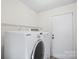 Laundry room with Samsung washer and dryer and shelving at 10423 Brawley Ln, Charlotte, NC 28215