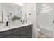 Modern bathroom with double vanity, gray cabinets, and a shower/tub combo at 2036 White Cypress Ct # Kh10, Charlotte, NC 28216