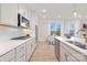 Modern kitchen with white cabinets, stainless steel appliances, and an island at 2036 White Cypress Ct # Kh10, Charlotte, NC 28216