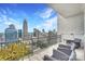 Relax on this roomy balcony, with scenic cityscape views and ample seating at 215 N Pine St # 3705, Charlotte, NC 28202