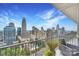 Balcony with seating overlooking a panoramic city skyline and lush greenery at 215 N Pine St # 3705, Charlotte, NC 28202