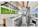 Modern residential bar featuring living wall, counter seating, city views and beverage center at 215 N Pine St # 3705, Charlotte, NC 28202