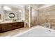 Bathroom showcasing a soaking tub, separate shower, and stylish vanity with double sinks at 215 N Pine St # 3705, Charlotte, NC 28202