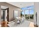 Bright dining room with a modern chandelier, seating for six and access to a balcony at 215 N Pine St # 3705, Charlotte, NC 28202
