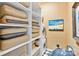Bright laundry room with washer, dryer, storage shelves and decorative art at 215 N Pine St # 3705, Charlotte, NC 28202