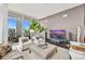 Spacious living area with floor-to-ceiling windows offering city views and a cozy seating arrangement at 215 N Pine St # 3705, Charlotte, NC 28202