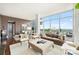 Light-filled living area with leather sofa, area rug, and city views at 215 N Pine St # 3705, Charlotte, NC 28202