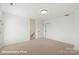 Bedroom featuring neutral carpet, two closets and a door to the hallway at 5840 Pittmon Ln, Kannapolis, NC 28081