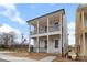 Charming two-story home boasts a black-railed porch, welcoming entrance, and light pink facade at 5840 Pittmon Ln, Kannapolis, NC 28081