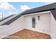 Exterior balcony with tile flooring, vinyl siding, exterior door and light at 5850 Pittmon Ln, Kannapolis, NC 28081