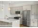 Close-up of a modern kitchen featuring stainless steel appliances and stylish light fixtures at 5850 Pittmon Ln, Kannapolis, NC 28081