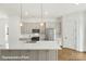 Bright and modern kitchen island with stainless steel appliances and attractive pendant lighting at 5850 Pittmon Ln, Kannapolis, NC 28081