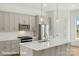 Modern kitchen with stainless steel appliances, light grey cabinets, and a white countertop island at 5850 Pittmon Ln, Kannapolis, NC 28081