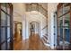 Two-story foyer with hardwood floors and ornate staircase at 13824 Claysparrow Rd, Charlotte, NC 28278