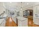 Modern kitchen featuring a large island, white cabinetry, and granite countertops at 13824 Claysparrow Rd, Charlotte, NC 28278