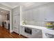 Modern kitchen with white cabinetry, stainless steel appliances, and a view into the laundry room at 13824 Claysparrow Rd, Charlotte, NC 28278