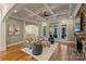 Bright living room with hardwood floors, a fireplace, and views of the backyard at 13824 Claysparrow Rd, Charlotte, NC 28278