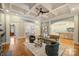 Spacious living room features hardwood floors, a coffered ceiling, and views into the kitchen and dining areas at 13824 Claysparrow Rd, Charlotte, NC 28278