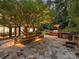 Outdoor kitchen with stone counters, grill, and patio seating at 13824 Claysparrow Rd, Charlotte, NC 28278